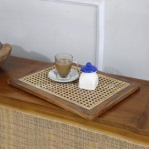 Rectangular rattan tray with tightly handwoven fibers and natural finish, designed for serving food and drinks or for use as a decorative home decor element.