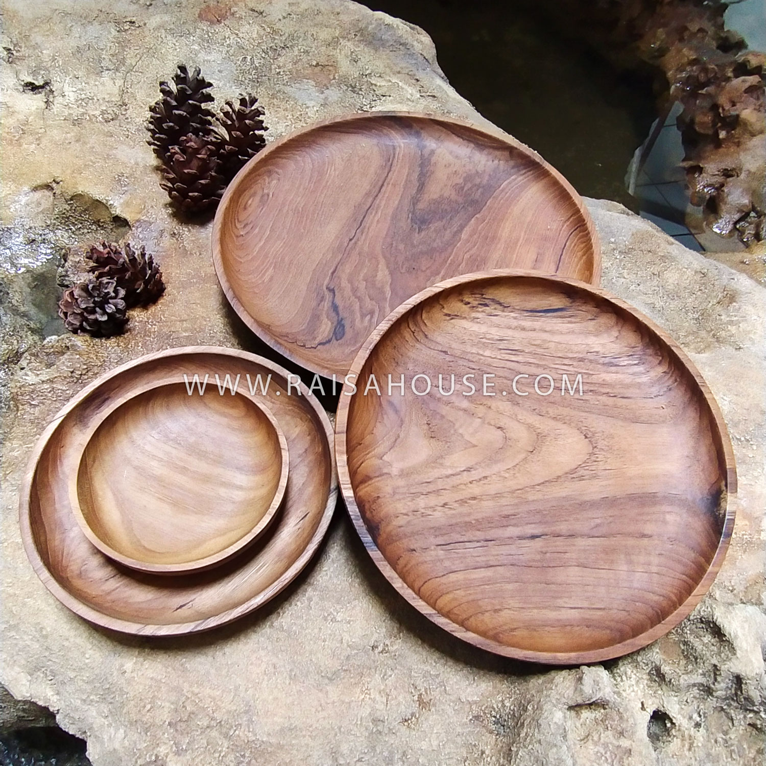 Medium round wooden plate crafted from solid wood with visible natural grain, perfect for serving appetizers, snacks, or tabletop styling.