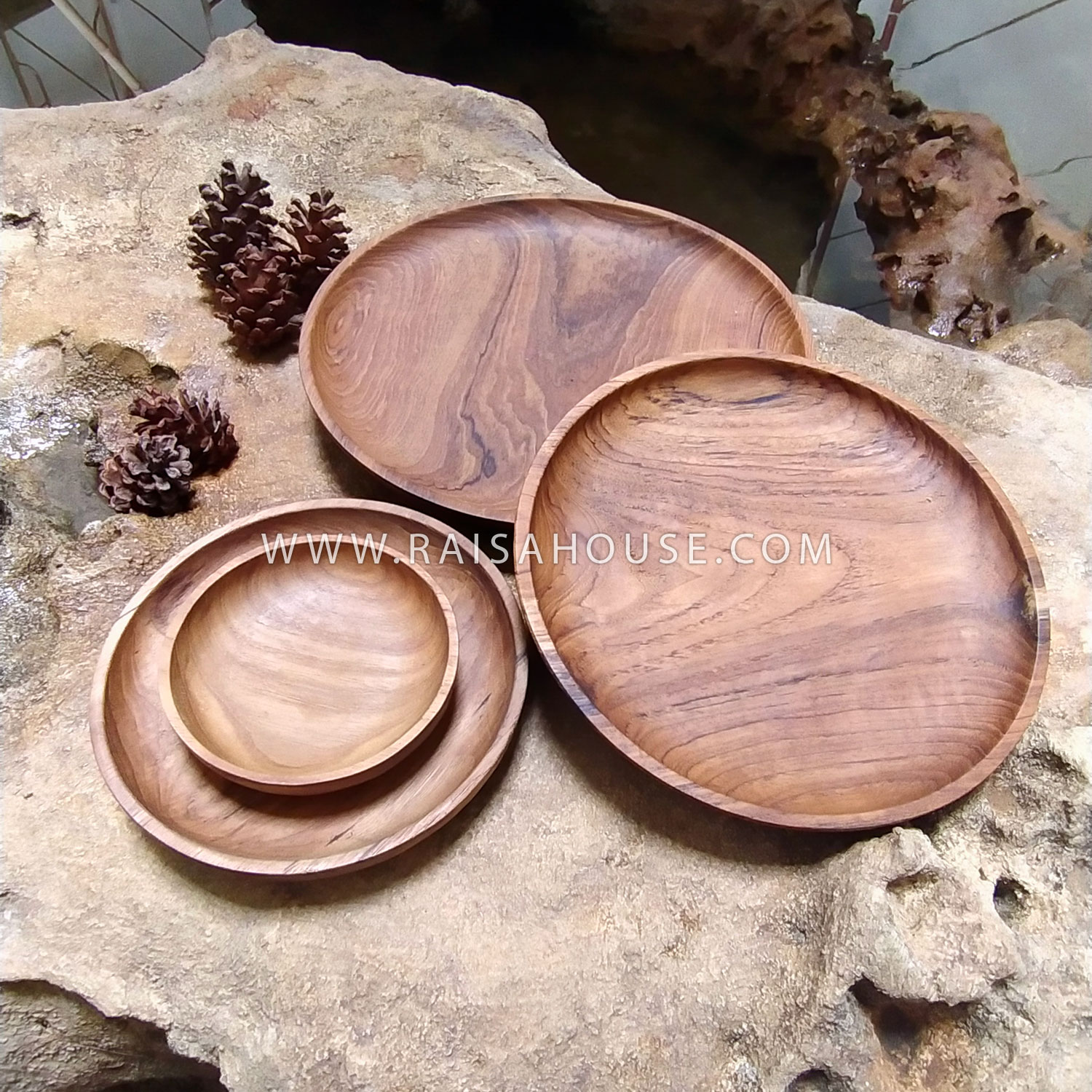 Medium round wooden plate crafted from solid wood with visible natural grain, perfect for serving appetizers, snacks, or tabletop styling.