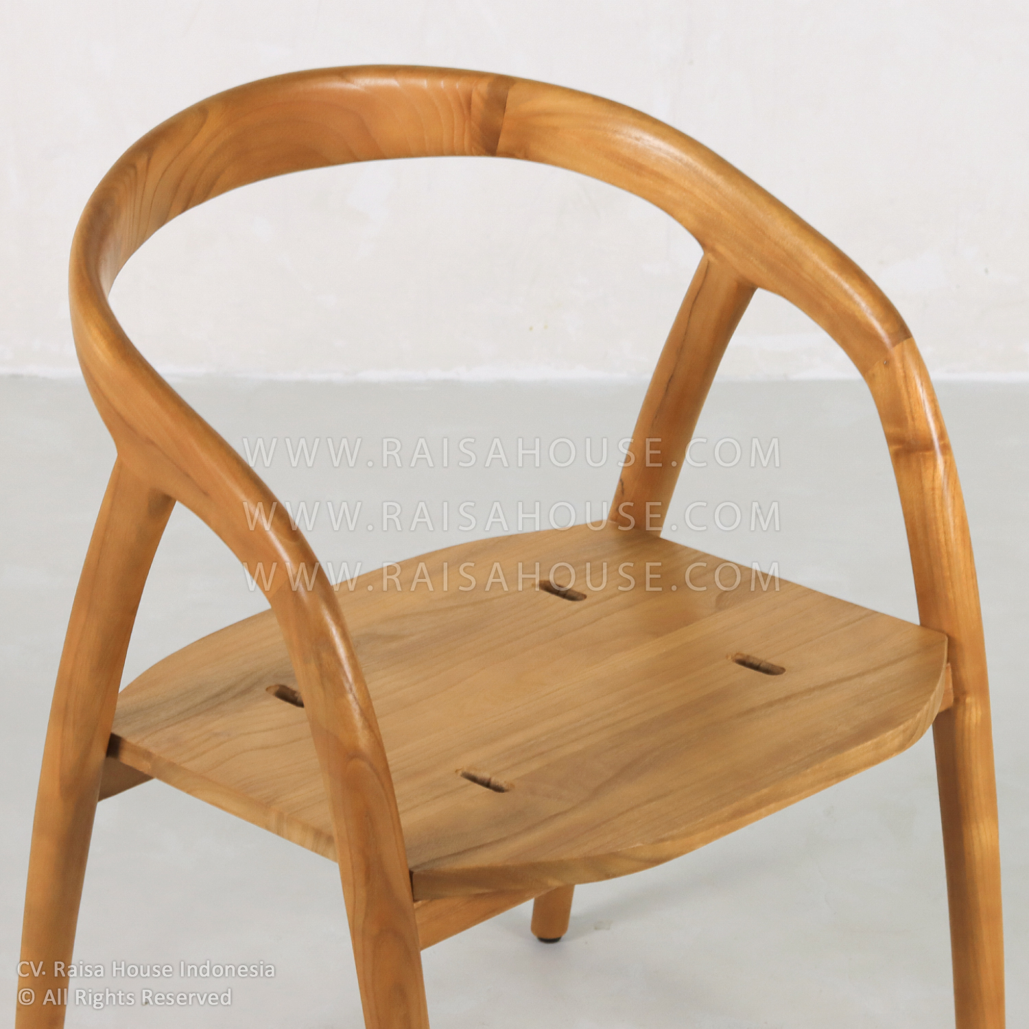 The Jovanca armchair is styled after Japandi furniture, featuring a natural teak frame with a curved backrest and padded seat.